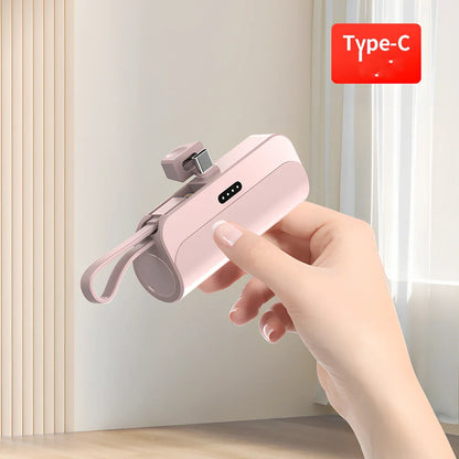 White capsule power bank showing compact 79mm size with USB charging ports visible