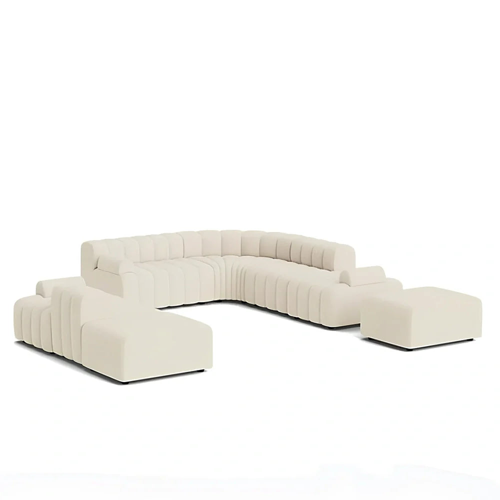 Off-white curved modular sofa with fleece fabric in corner configuration showing multiple connected pieces