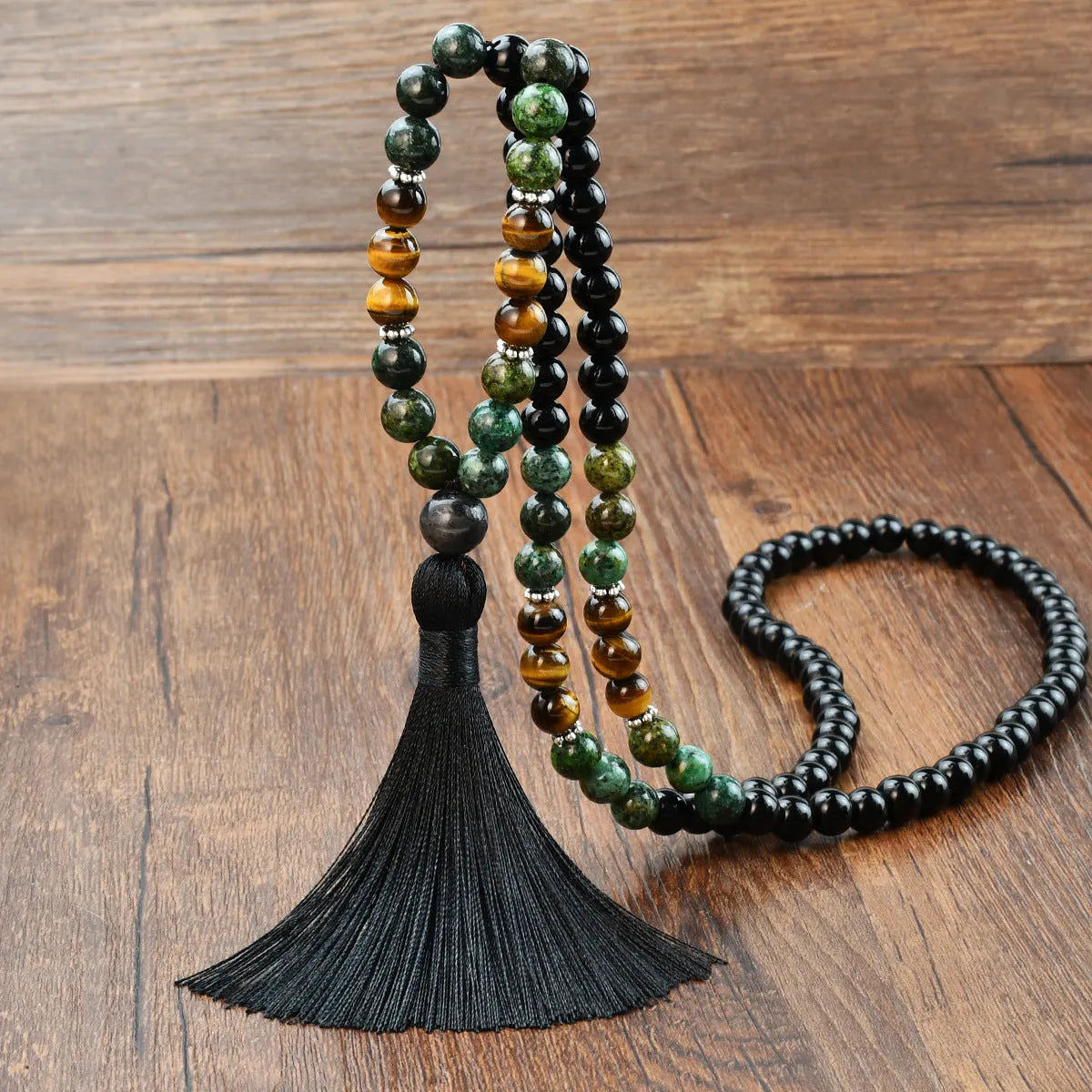 Long beaded necklace with geometric pendant and natural stone tassels in green aventurine.