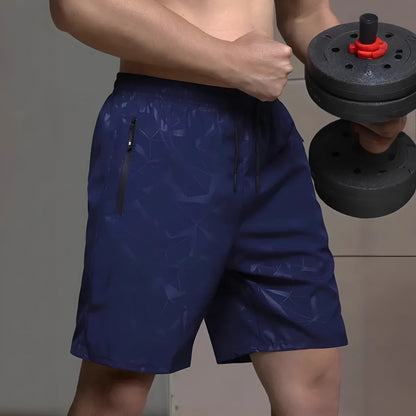 Men's loose-fit casual sports shorts in grey with a printed pattern, showing elastic waistband and fifth-pants length.