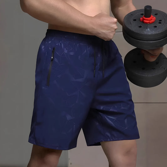 Men's loose-fit casual sports shorts in grey with a printed pattern, showing elastic waistband and fifth-pants length.