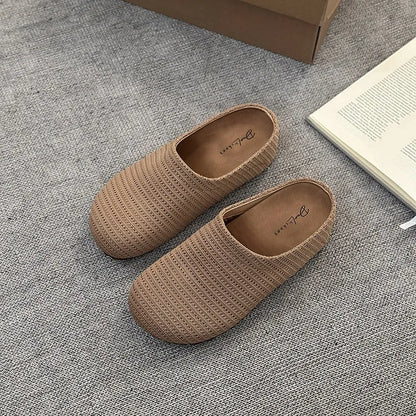 Women's non-slip cloth slippers with rubber sole in beige colour showing round toe design