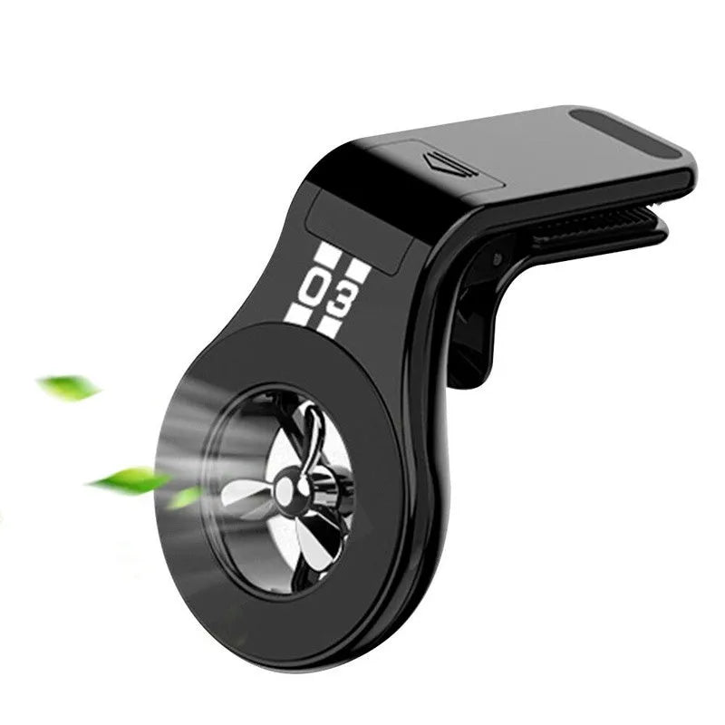 Black magnetic car phone holder attached to air vent with smartphone mounted and fragrance slices visible