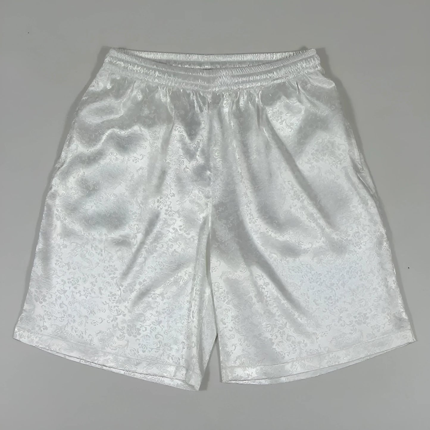 Men's black Tai Chi shorts with a white drawstring elastic waistband laid flat.