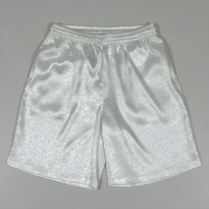 Men's black Tai Chi shorts with a white drawstring elastic waistband laid flat.