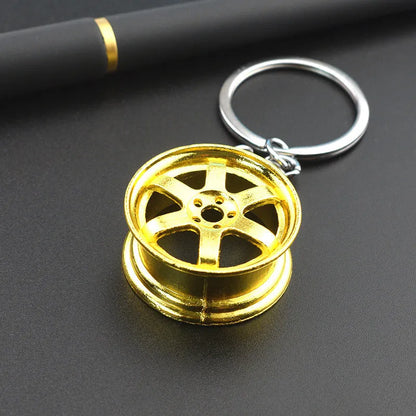 Zinc alloy car wheel hub keychain in black, gold and silver colour options