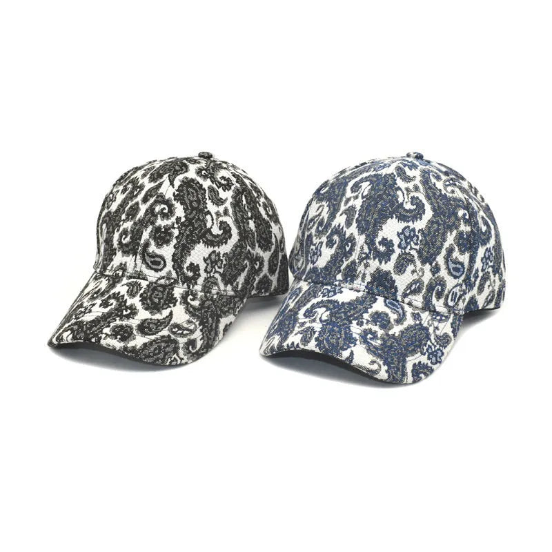 Blue polyester baseball cap with white paisley pattern print, showing dome crown style.