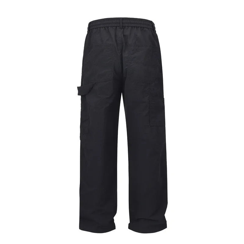 Black tooling paratrooper pants with elastic waist drawstring closure and baggy three-dimensional cutting