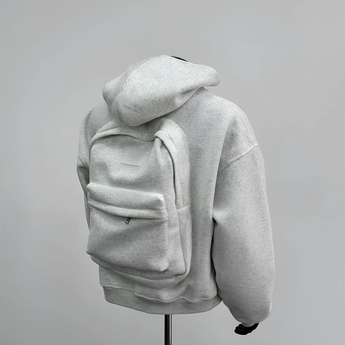 Light grey men's backpack design hooded coat jacket on a hanger.