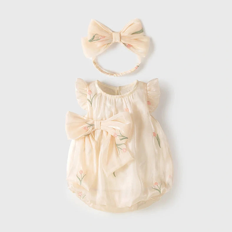 Apricot-coloured sleeveless baby jumpsuit with triangle design on hanger