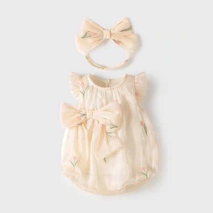 Apricot-coloured sleeveless baby jumpsuit with triangle design on hanger