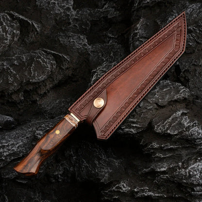 Damascus steel kitchen knife with 21.8cm blade and milky off-white finish on cutting board