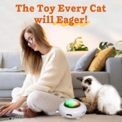 White automatic cat toy with colourful feathers and cleaning ring attachment on floor