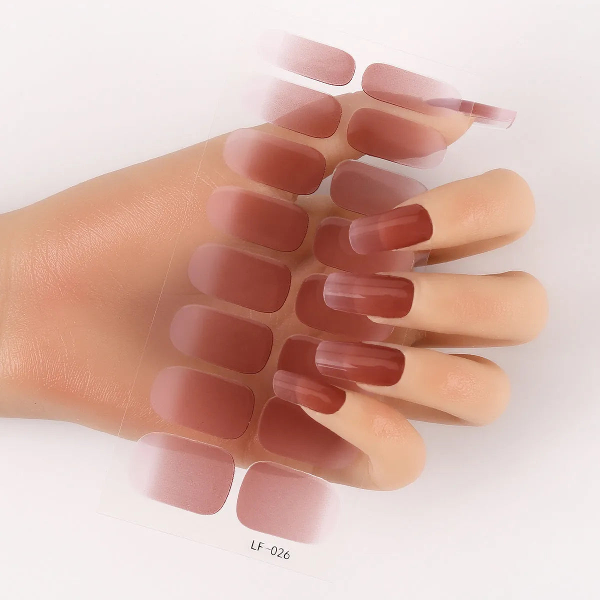 Sheet of 16 small design nail art stickers including cross, rose, tulip and marble patterns.