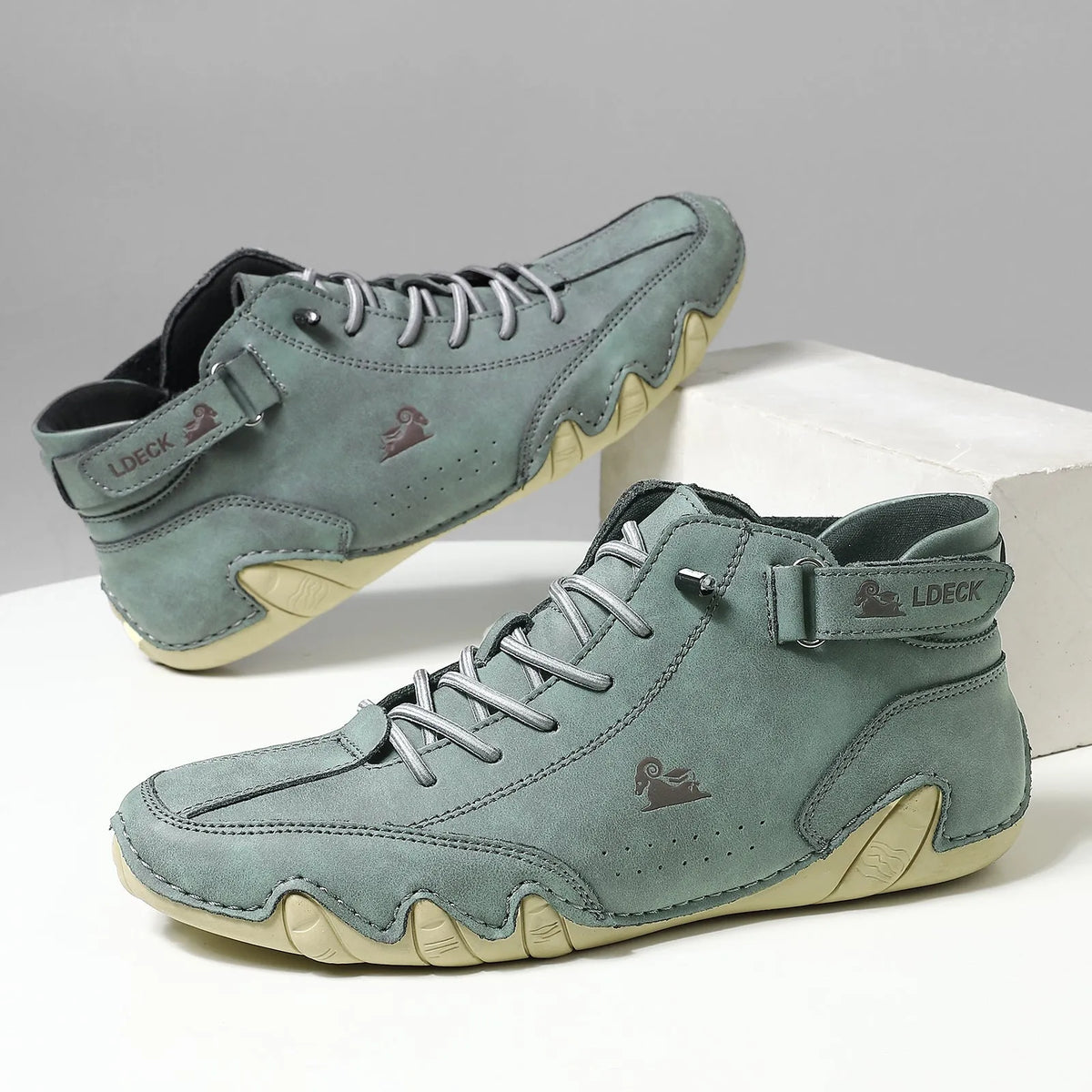 High top men's shoes in khaki with rubber soles and microfiber upper, showing round toe and middle tube height