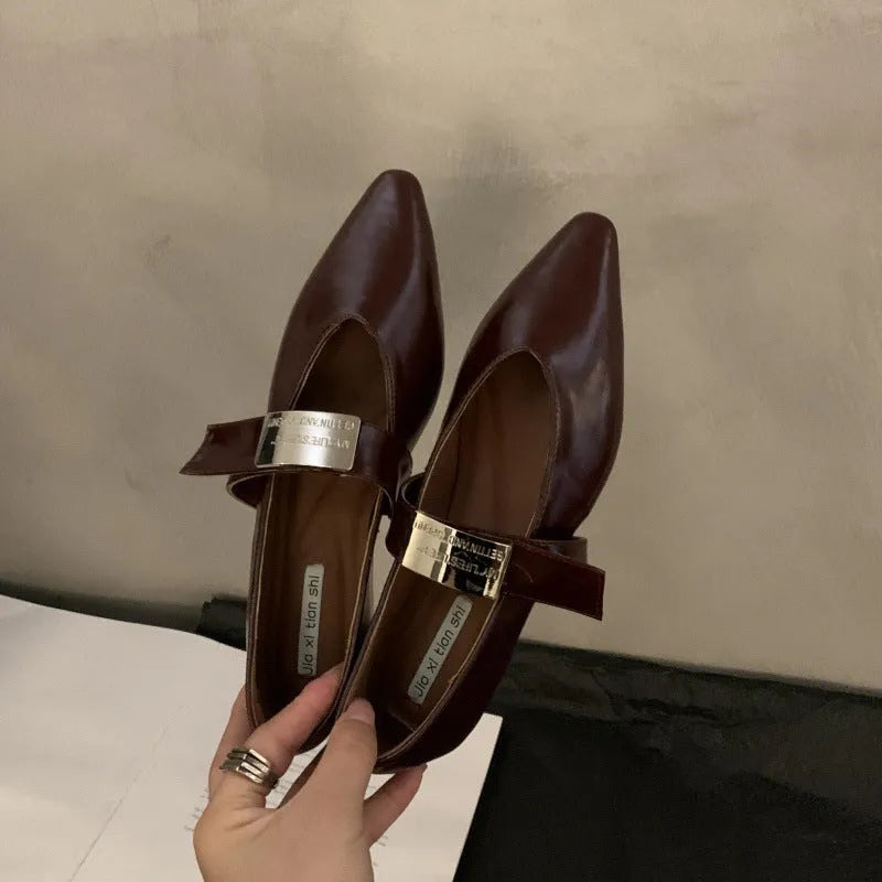 Women's silver Mary Jane buckle pumps with pointed toe and low flat heel, shown in black and wine red colours.