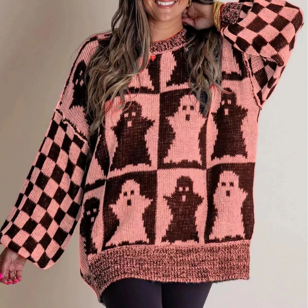 A stylish Halloween sweater featuring a unique pumpkin and ghost graphic design, available in a variety of fashion-forward colors.