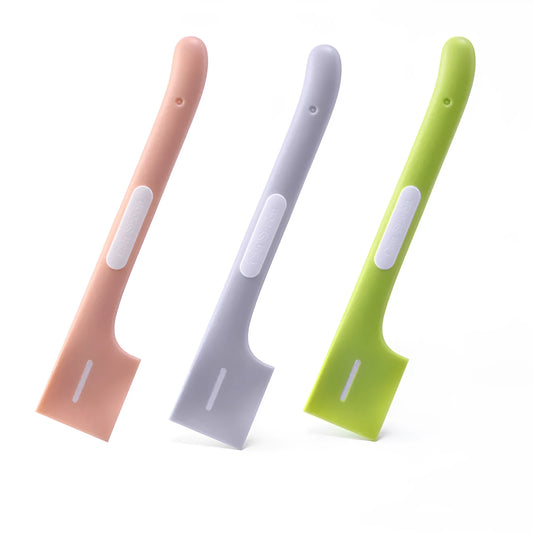 Green long-handled plastic spoon for scooping pet food from a can.