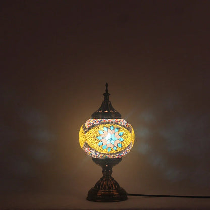 Glass table lamp with 150mm diameter shade and 330cm cord on wooden surface