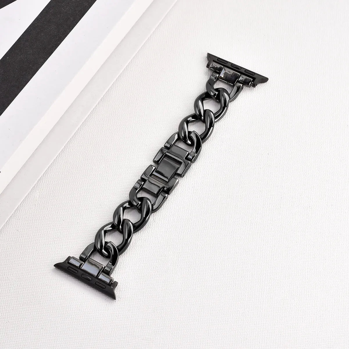 Silver metal link watch strap for Apple Watch with 22mm connectors on a grey background
