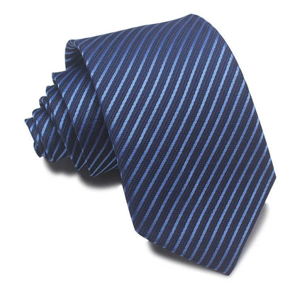 Close-up of a red and black striped jacquard weave tie with an arrow tip, showing texture.
