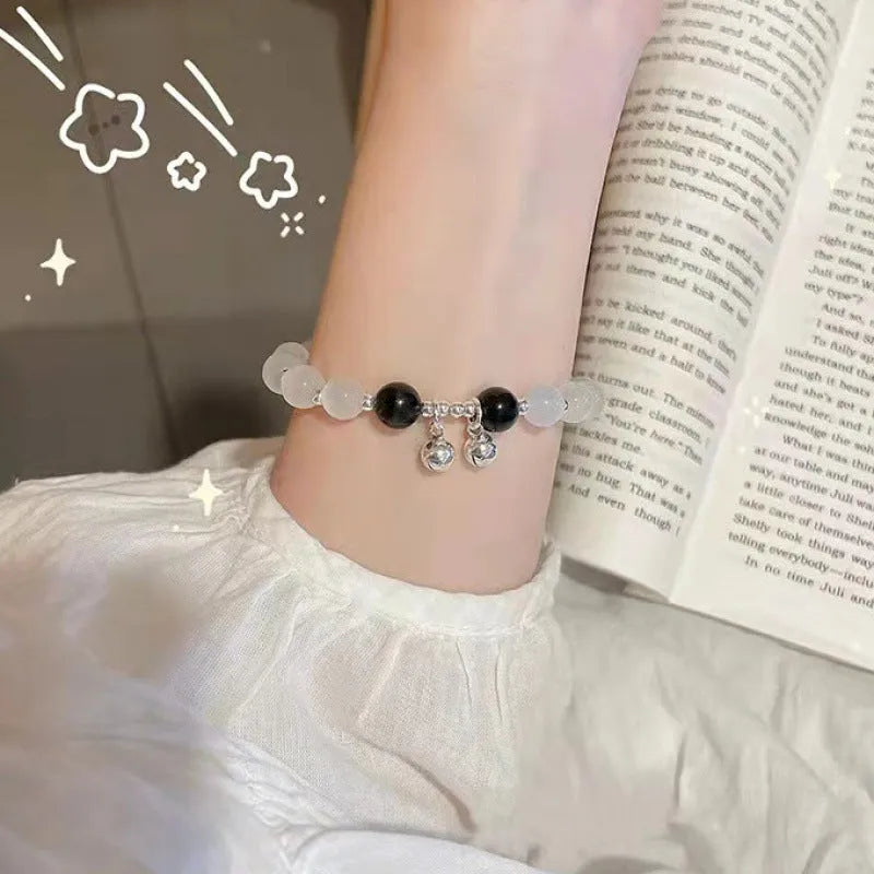 Chinese style glass bead bracelet with bamboo joint design on wrist.