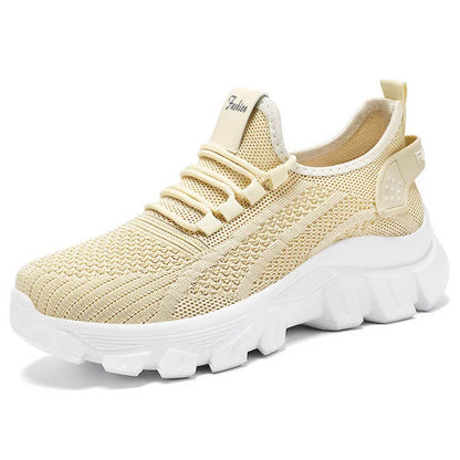 Women's white Flyknit sneakers with a thick PVC sole and lace-up front.