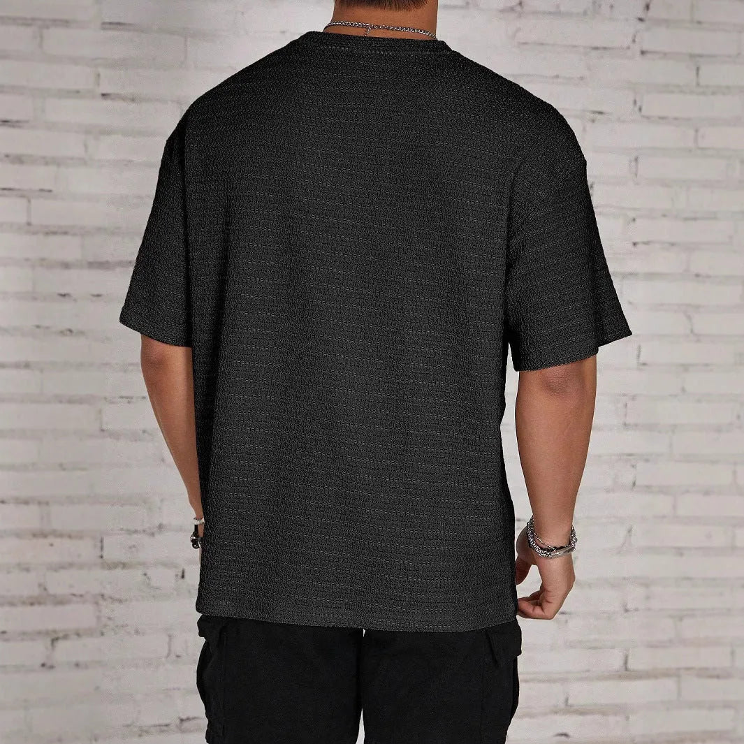 Men's slim-fit solid colour short sleeve T-shirt on a hanger, showing lightweight fabric.