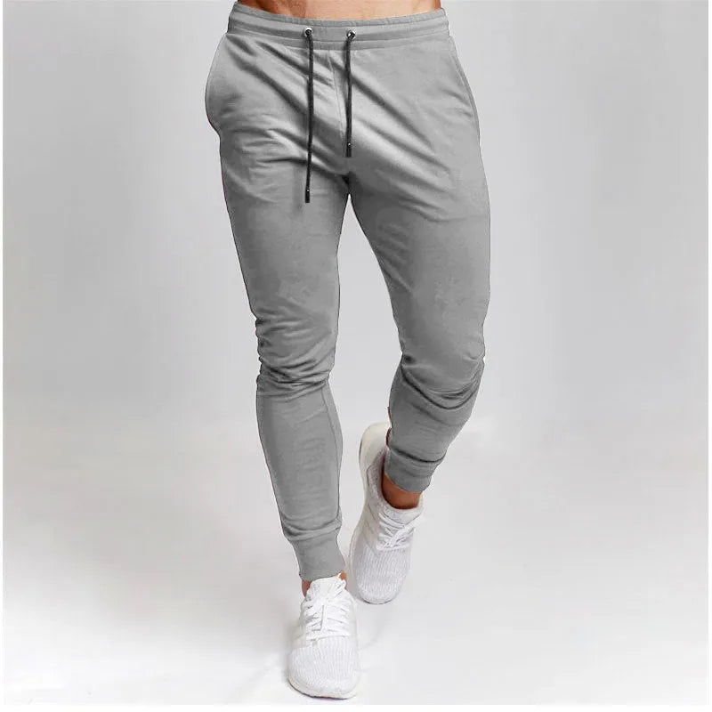 Men's cotton skinny sports trousers with drawstring and belt, available in five solid colours