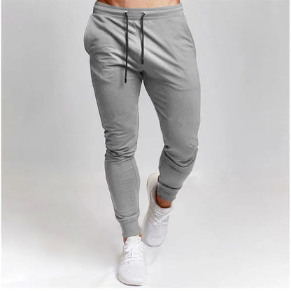 Men's cotton skinny sports trousers with drawstring and belt, available in five solid colours