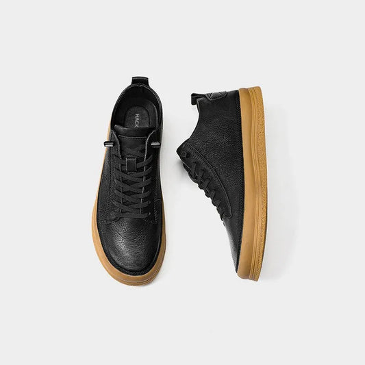 Men's black casual shoes with round toe, lanyard closure, and soft rubber soles on a neutral background