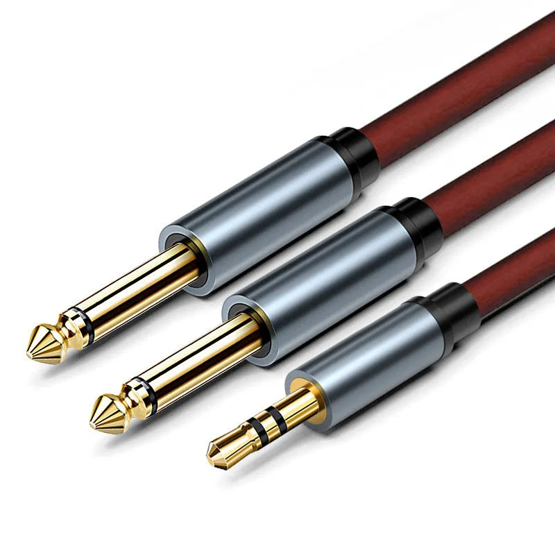 A 3.5mm stereo jack to two 6.5mm mono jack audio cable on a grey background.