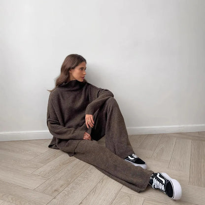 Women's acrylic side-slit sweater suit in dark grey, featuring a top and trousers for a coordinated two-piece set.