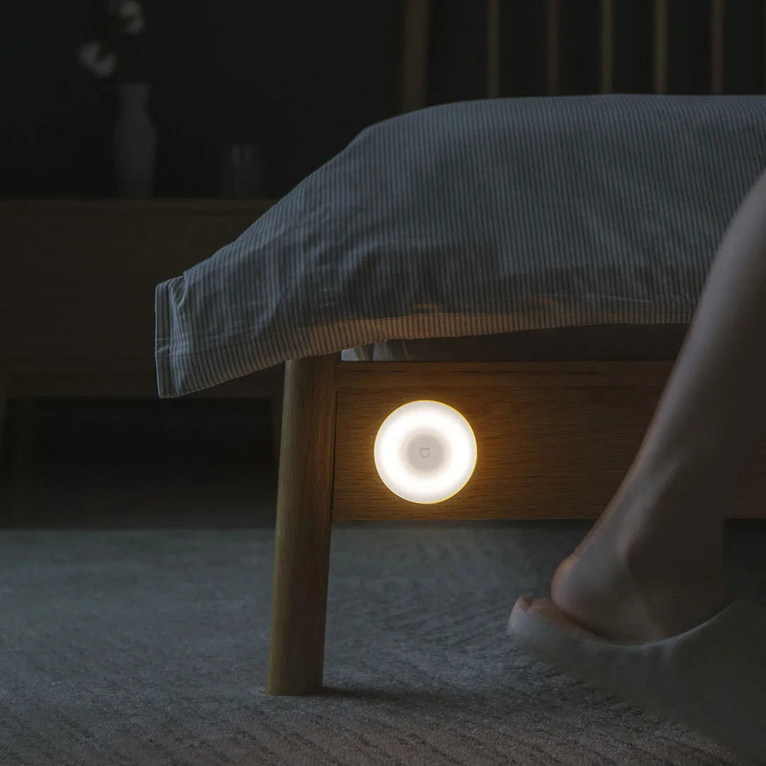 White modern bedside table lamp with human body sensor and Bluetooth connectivity, dimensions 94mm by 94mm by 71mm.