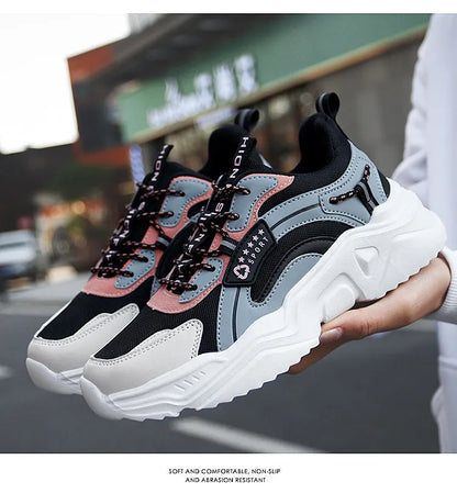 Women's white casual sports shoes with mesh upper, thick sole, buckle strap, and round toe.