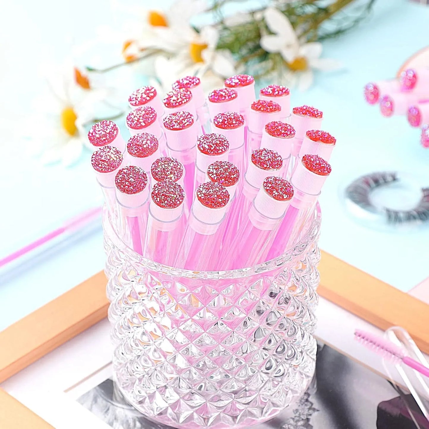 Disposable eyelash brushes in plastic storage tubes with spiral brush heads in four colours