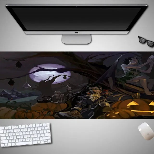 Oversized black Halloween-themed mouse pad with graphic design on a desk with keyboard and mouse
