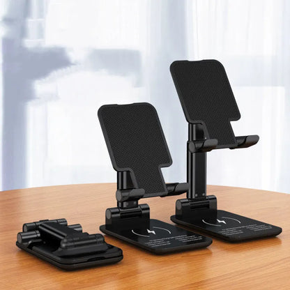 Black desktop wireless charging stand holding mobile phone at angle with power cord connected