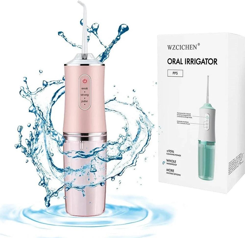 White oral irrigator with 4 nozzles showing water stream and USB charging port