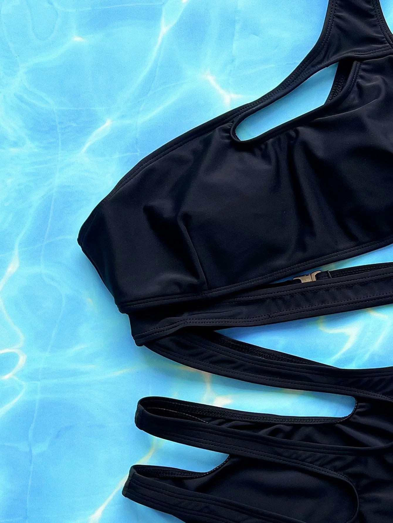 Black women's one-piece swimsuit with hollow out strap design showing front and back views