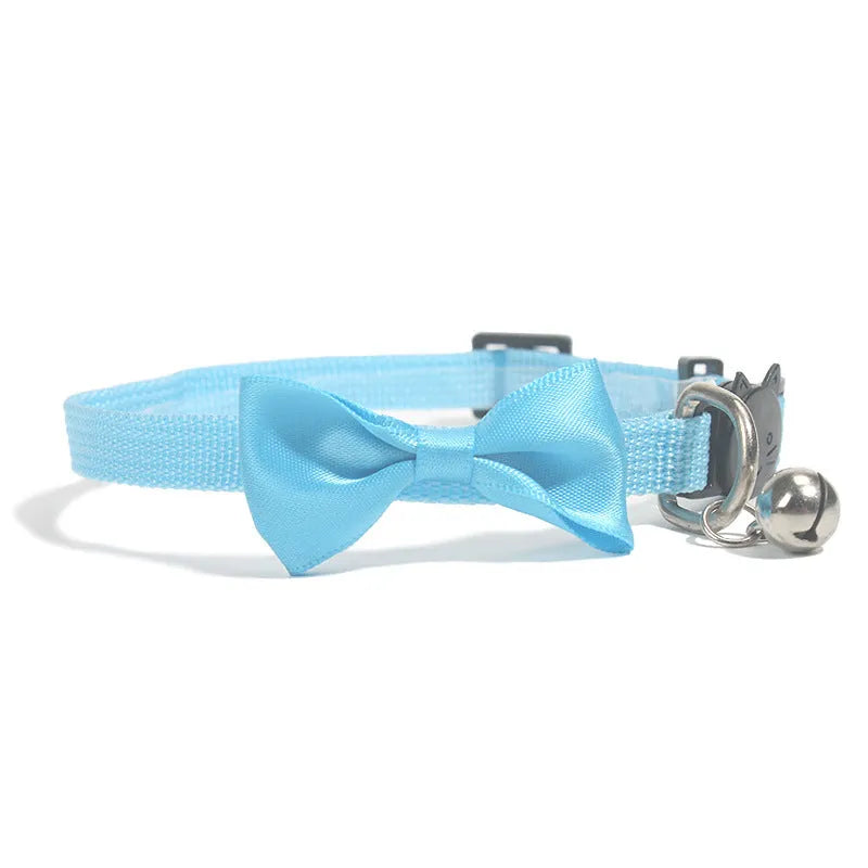 Striped nylon cat collar with decorative bow and bell in multiple colour options on a white background.