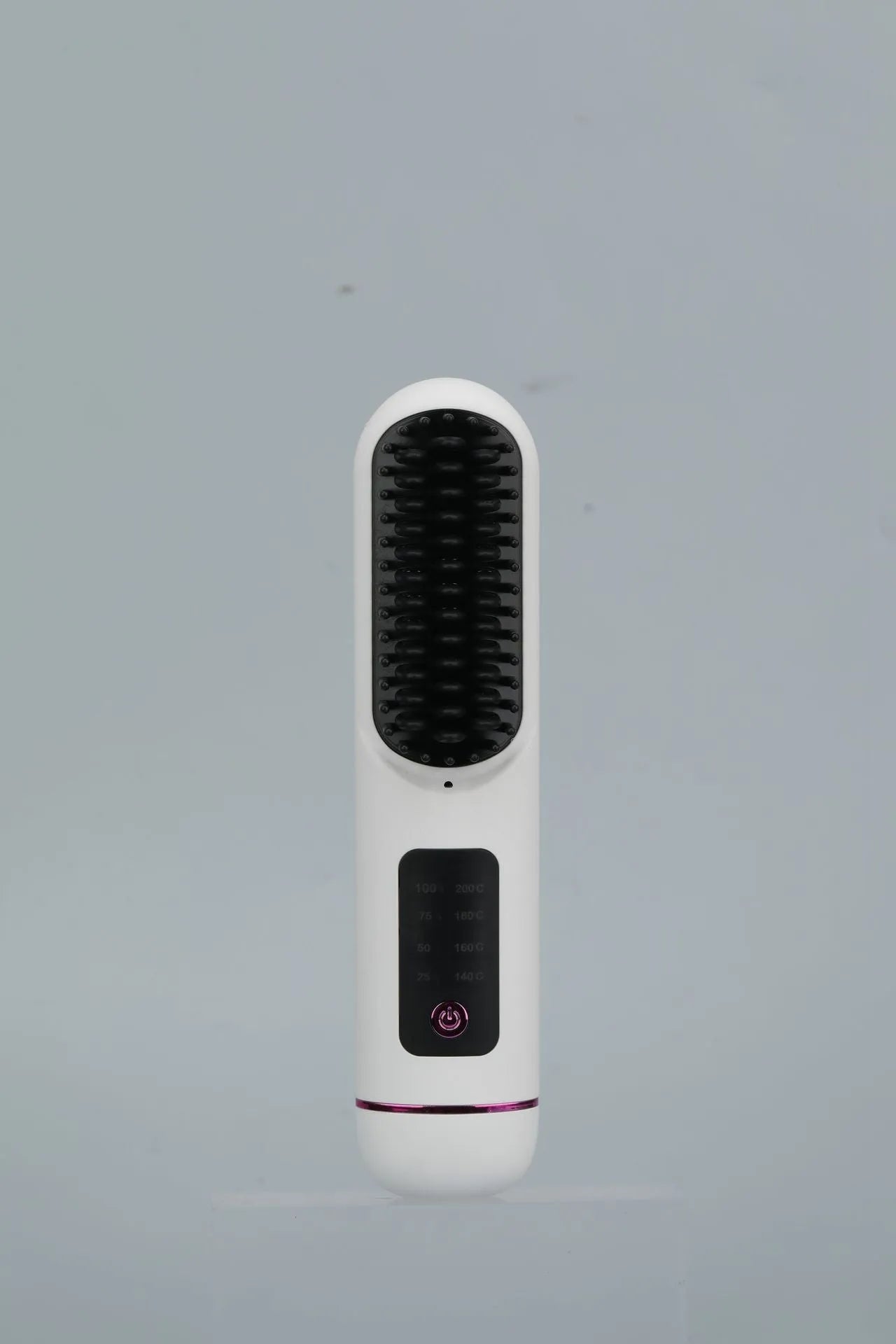 White USB-C rechargeable negative ion hair comb on a wooden table next to its charging cable.