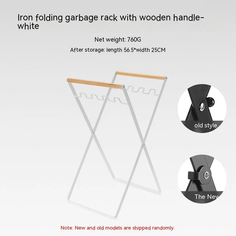 Black iron folding trash rack with wooden handles mounted on a wall holding a recycling bag.