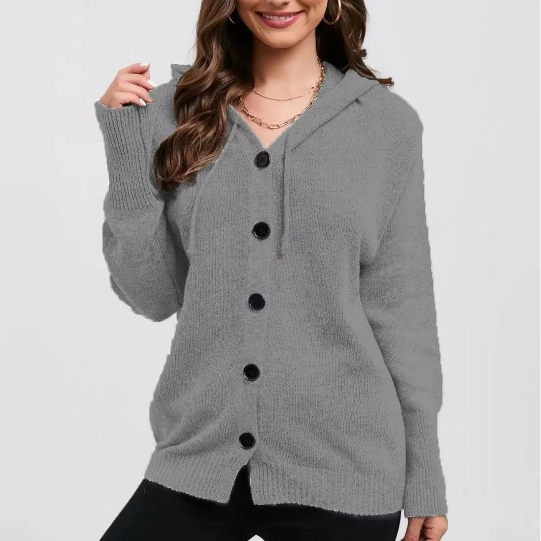 A woman wearing a loose, thick, hooded cotton cardigan in a solid colour.