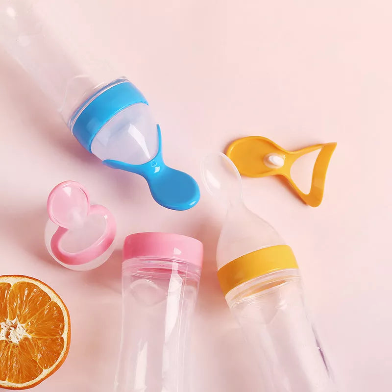 Silicone baby rice paste spoon feeding bottle with suction cup in blue, green, pink, yellow, and white
