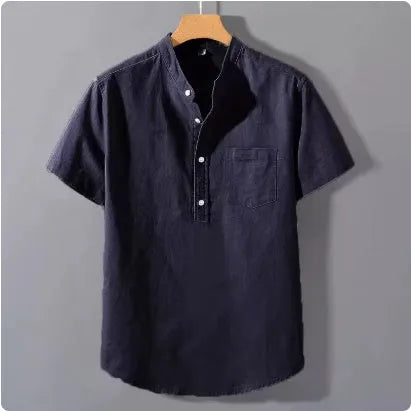 Man wearing a beige loose-fit linen blend casual shirt with a stand collar and short sleeves.
