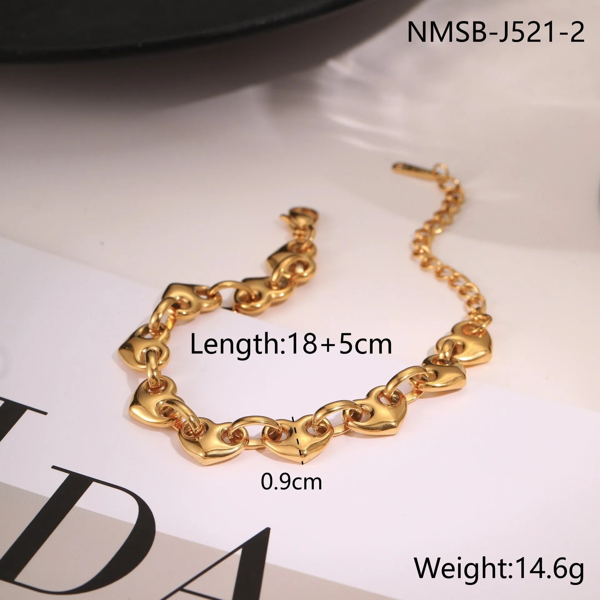Women's hollow heart bracelet in stainless steel with 18K gold plating, shown in colour block, gold, and steel finishes