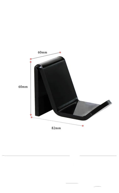 A universal black game controller mounting bracket shown installed on a wall.