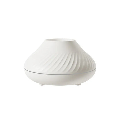 Beige volcanic flame aroma diffuser with LED lighting and mist output on wooden surface