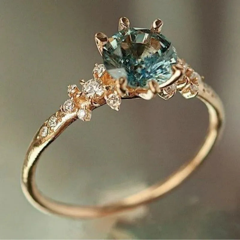 Geometric gold plated ring with chamfered square pattern and inlaid zircon stones in claw settings